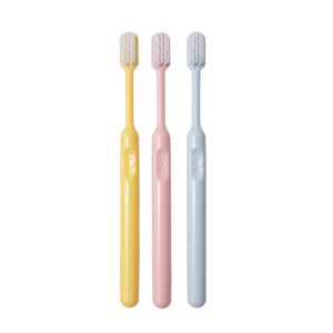 candy colored bucket shaped soft bristle small tipped toothbrush
